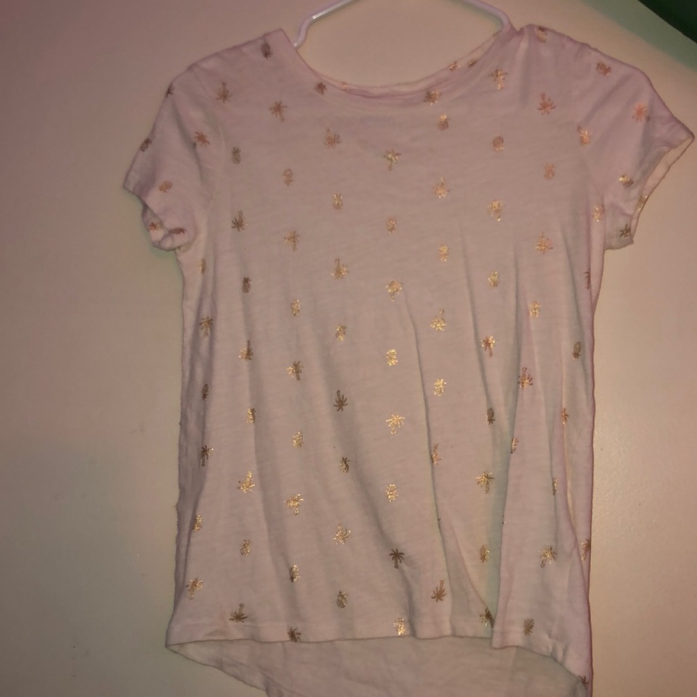 white shirt with golden palm trees and pineapples